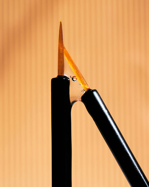 an image showing brushes with eyelash serum