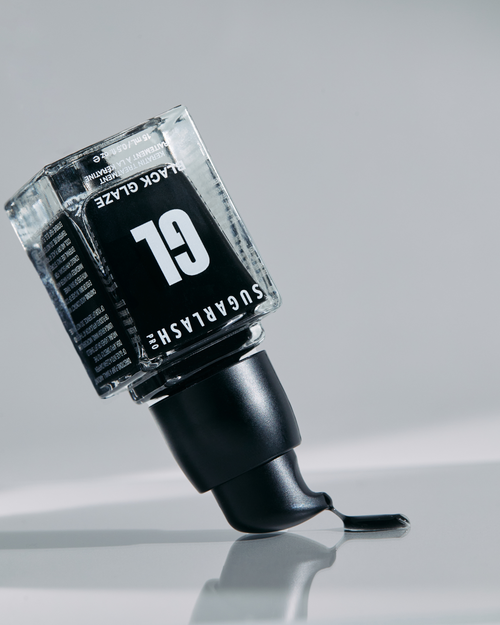 Black Glaze bottle upside down with product coming out of the pump for your eyelash extensions