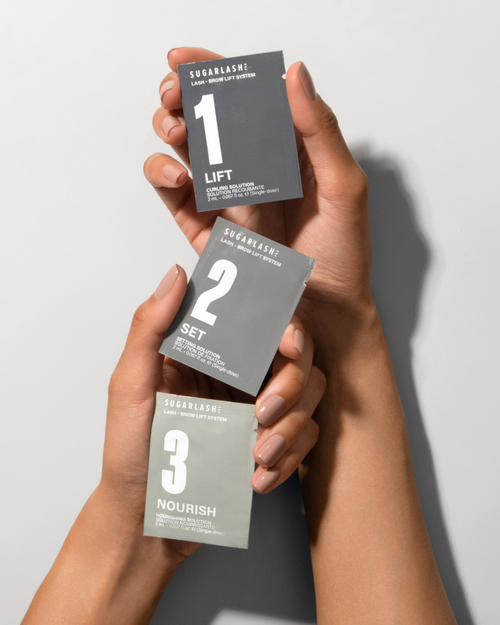A model holding Lift, Set and Nourish Lash and Eyebrow Lamination sachets.