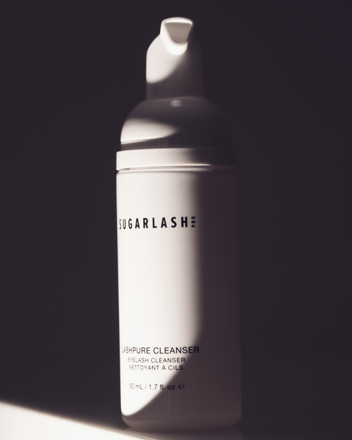 Shadowed image of bottle of LashPURE cleanser for eyelash extensions.
