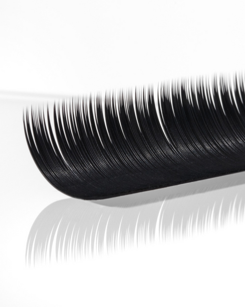 A strip of Runway Lashes for eyelash extensions on a white surface.