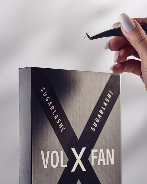 A model holding tweezers above a tray of VOL-X Pre-made Fans.