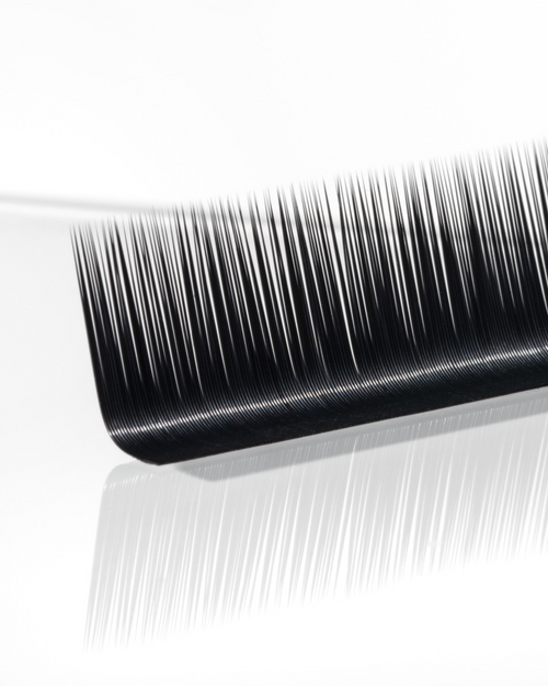 A close up of a strip of Flat lashes on a white background.