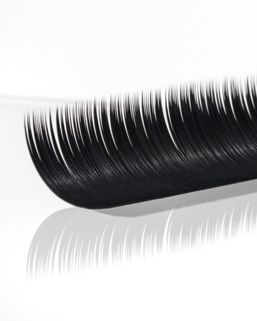 A strip of eyelash extensions on a white background.