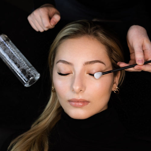 Lash artist cleansing model's lash extensions.