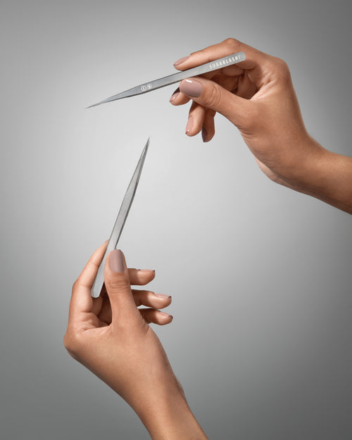 A model holding I-S Eyelash Extension Isolation Tweezers.