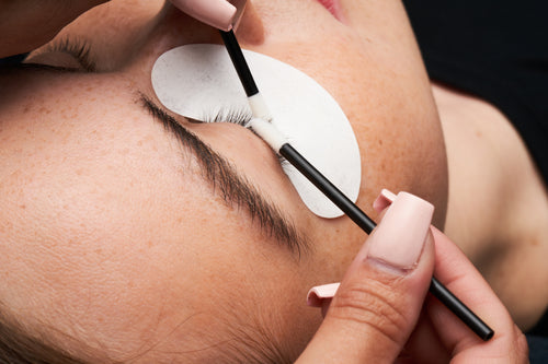 A lash artist prepping lashes for lash extensions.