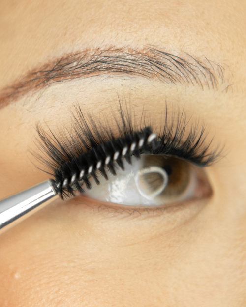 A Brush Wand brushing our lash extensions.