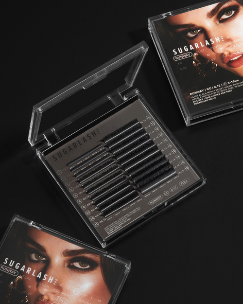 # trays of Runway lashes on a black surface.