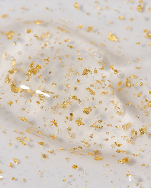 Close up of 24 karat gold Plump keratin treatment showing gold flake and gel texture