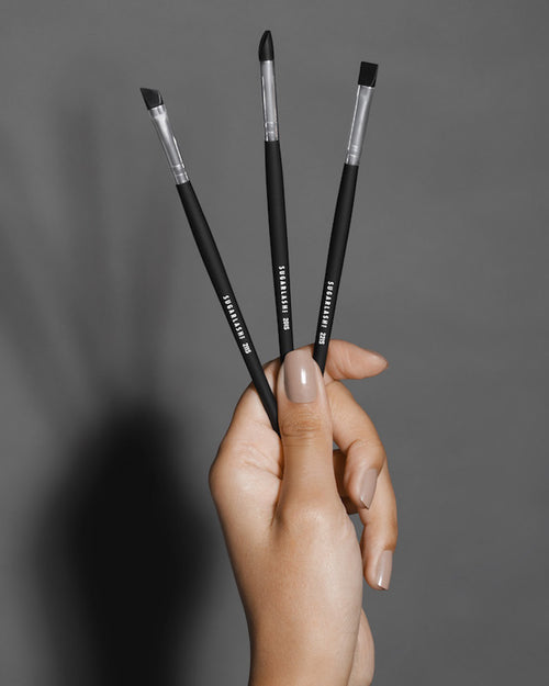 Model holding three Silicone Brushes for lash lifts and brow lamination.